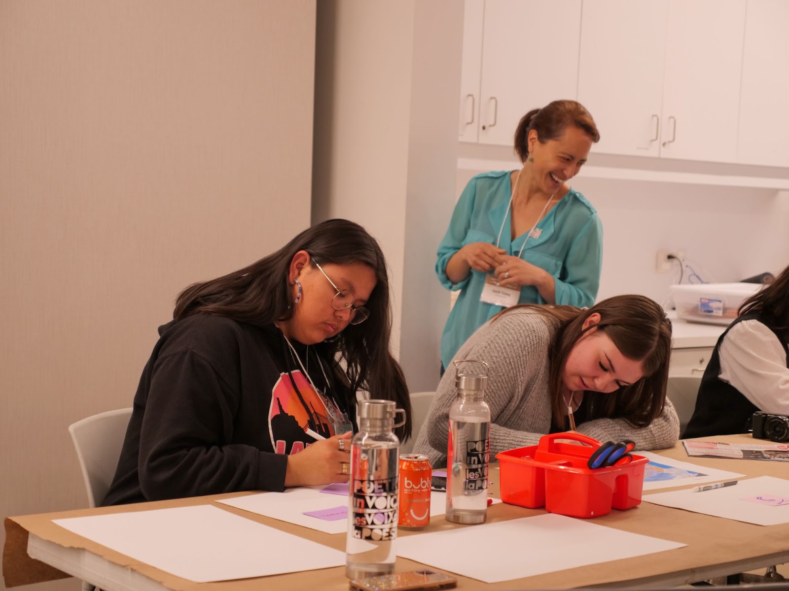 Sarah marvels as students Feather and Hannah dive deep into their work.