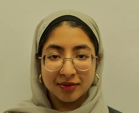 A young woman in a light green head scarf