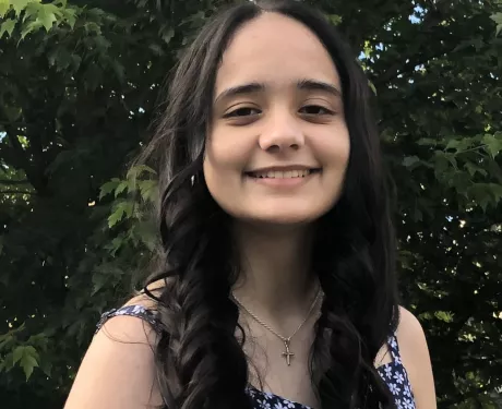 A young woman looks at the camera
