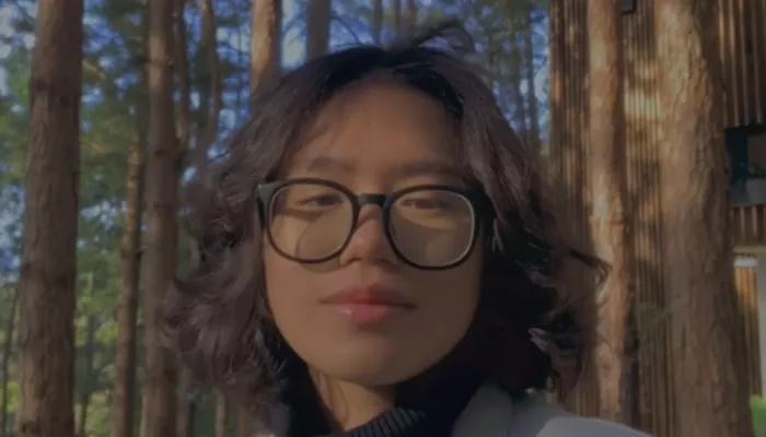 Young woman standing in the forest