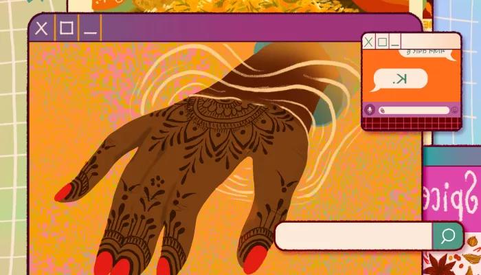 a hand decorated with henna coming through a computer screen