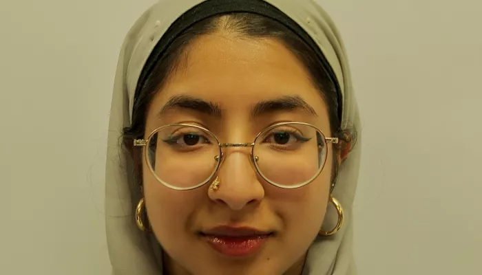 A young woman in a light green head scarf