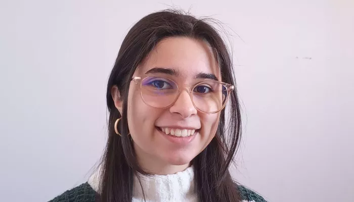 A young woman looks at the camera