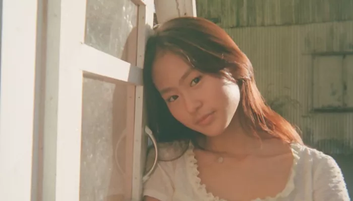 A young woman looks at the camera