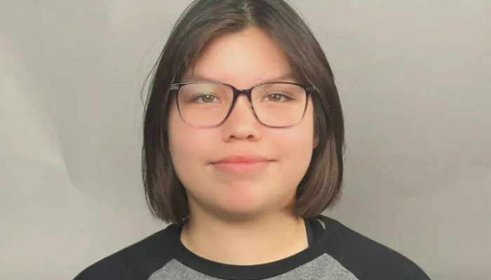 A young woman looks at the camera