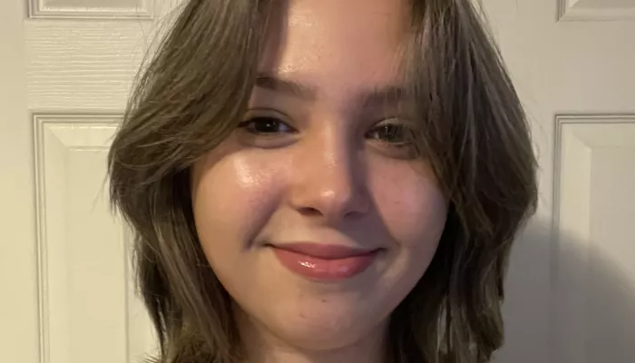 A young woman looks at the camera