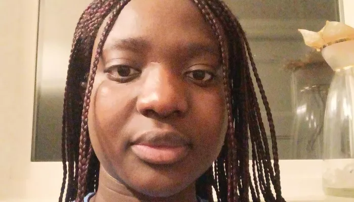 A young woman looks at the camera