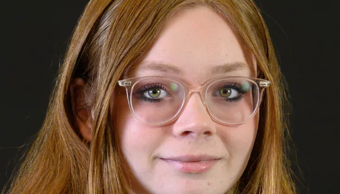 A young woman looks at the camera