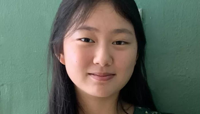A young woman looks at the camera