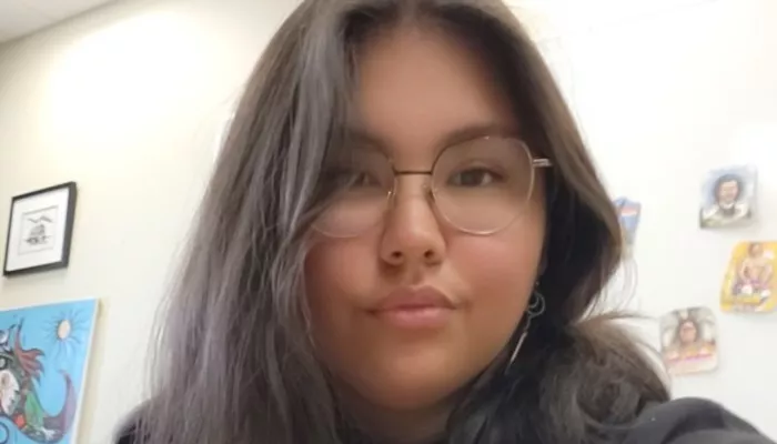 A young woman looks at the camera