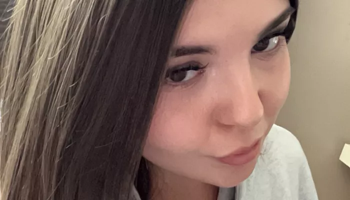 A young woman looks at the camera