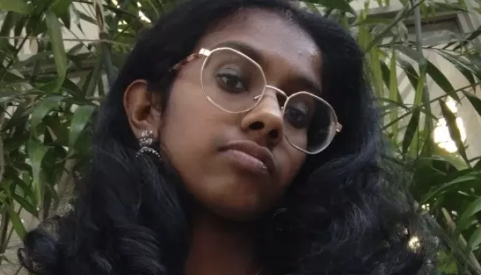 A young woman looks at the camera