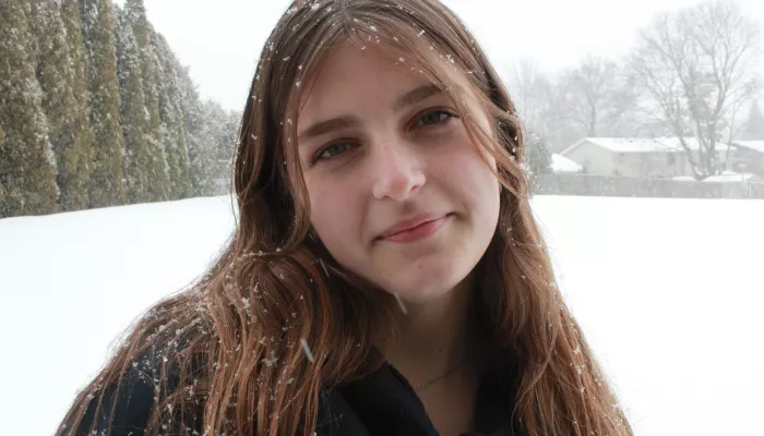 A young woman looks at the camera