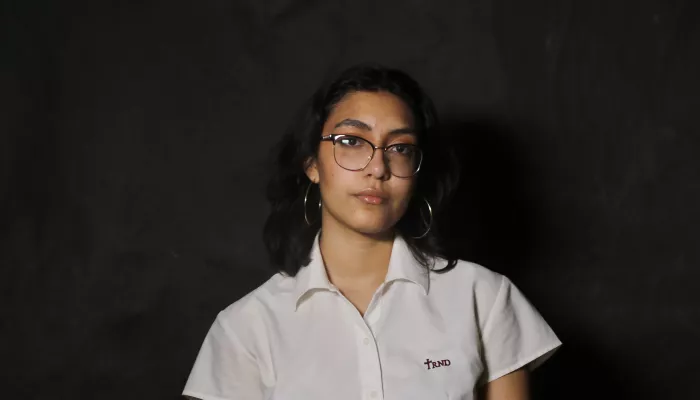 A young woman looks at the camera
