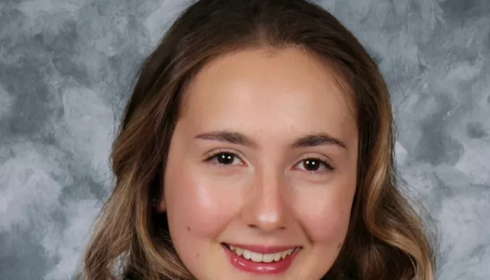 A young woman looks at the camera