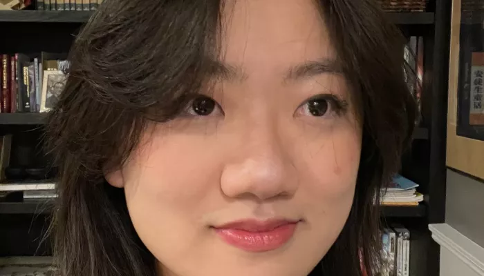 A young woman looks at the camera