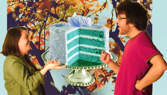 Two people with a layered cake over an autumn scene