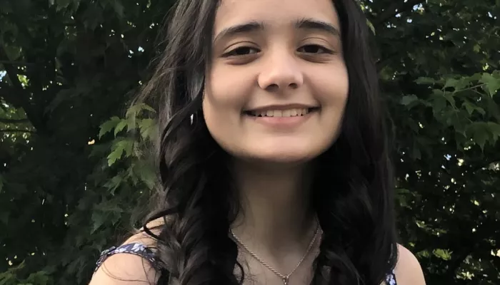 A young woman looks at the camera
