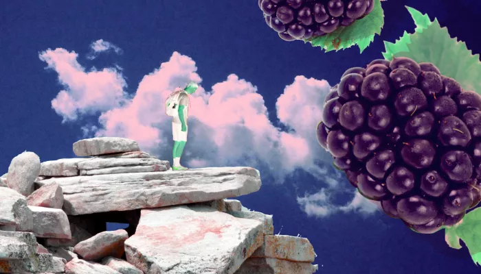 a person on a cliff with giant floating berries