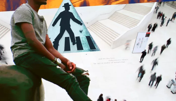 a man sitting in a busy traffic area